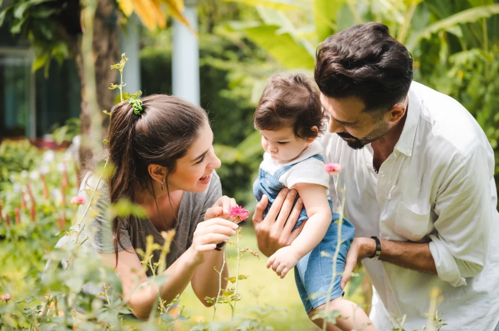Young homeowners enjoy backyard with young daughter