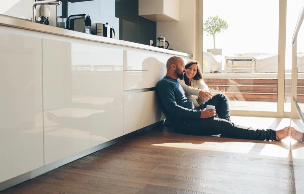 happy homeowners hang out in home kitchen