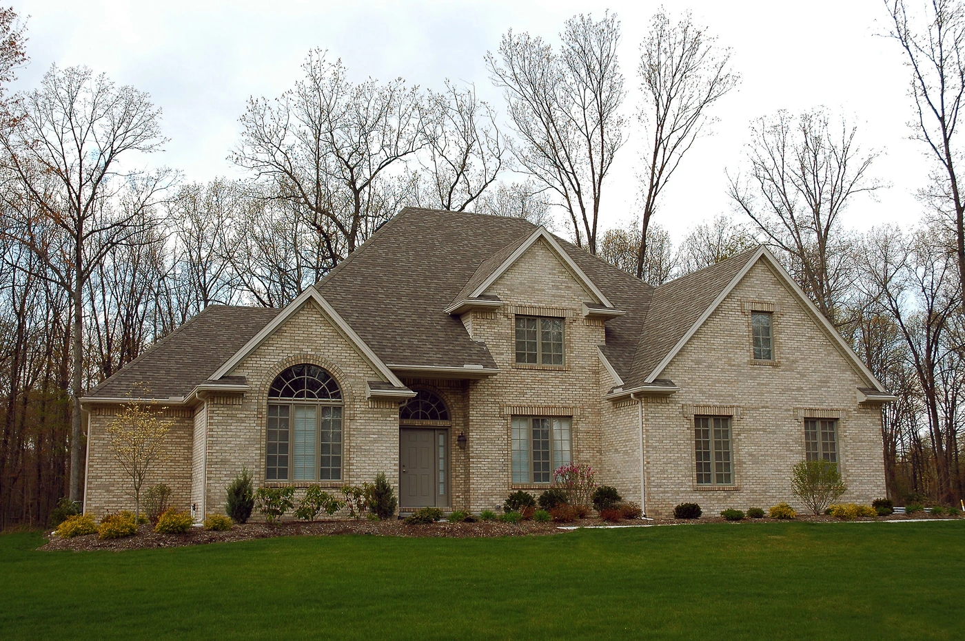 Beige brick home with shingle roof replacement in Mt Juliet