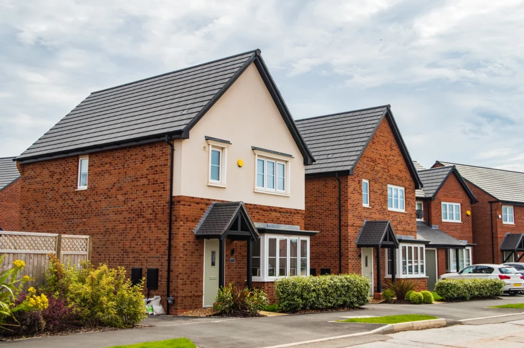 brick houses with new metal roofing installations