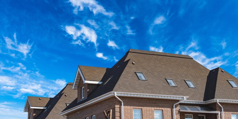 hip vs gable roof-hip style roof on a brick house