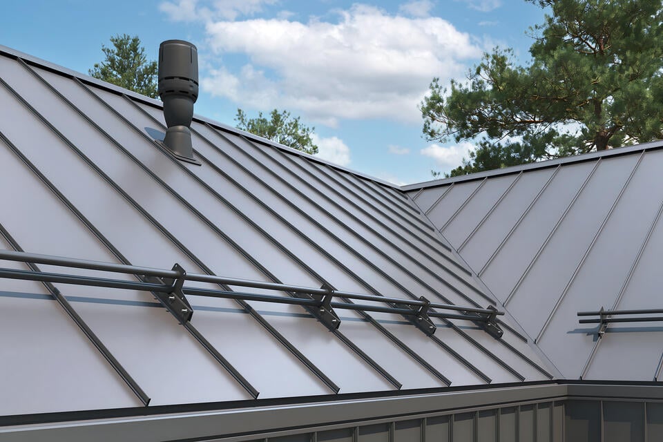 standing seam metal roof-close up of gray metal roofing on house with snow rails