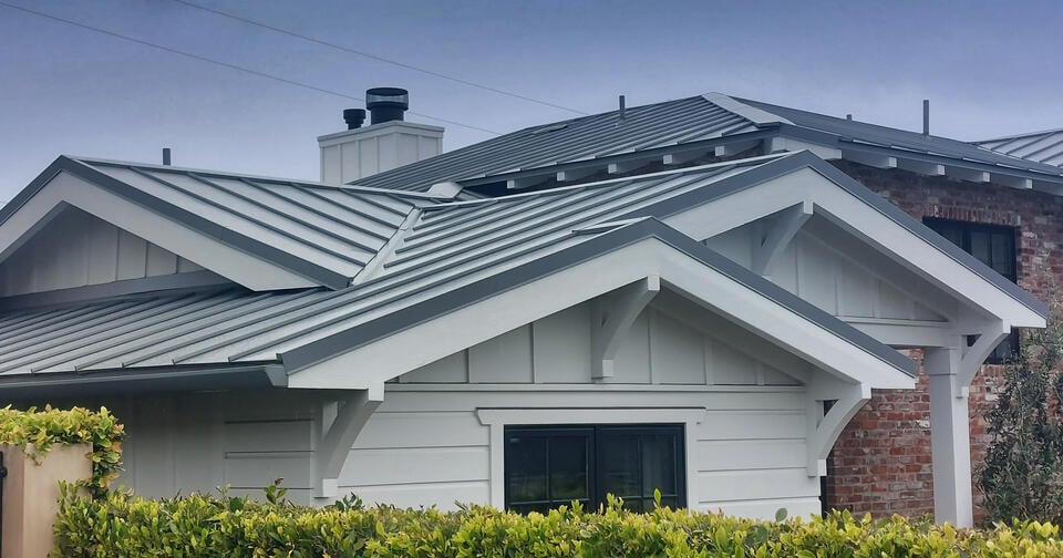 standing seam metal roof-light gray sided house with gray metal roofing